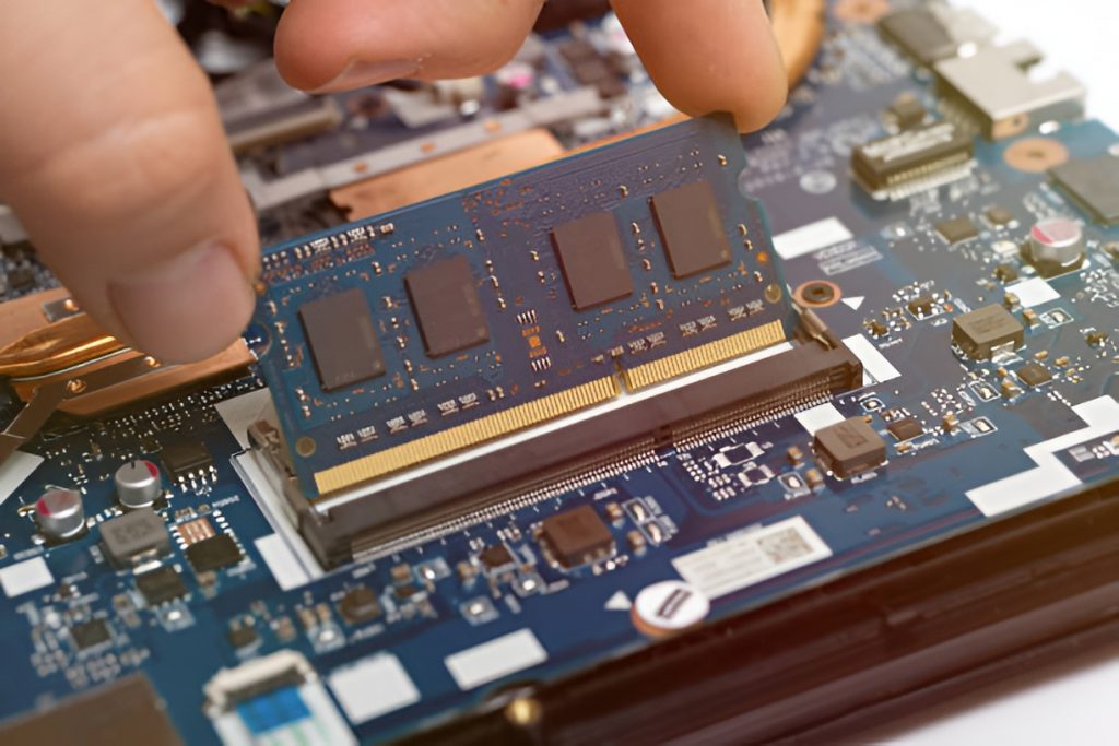 close-up of a person replacing laptop RAM